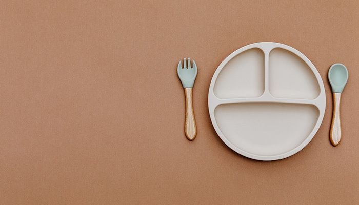 Empty kids plate with spoon and fork